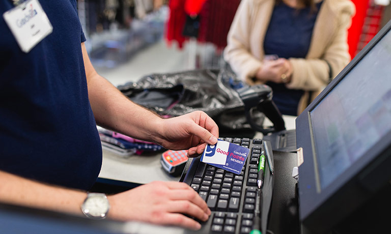 a Goodwill employee operates a computer at the checkout